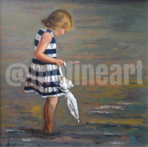 Little girl on the beach blue and white striped dress