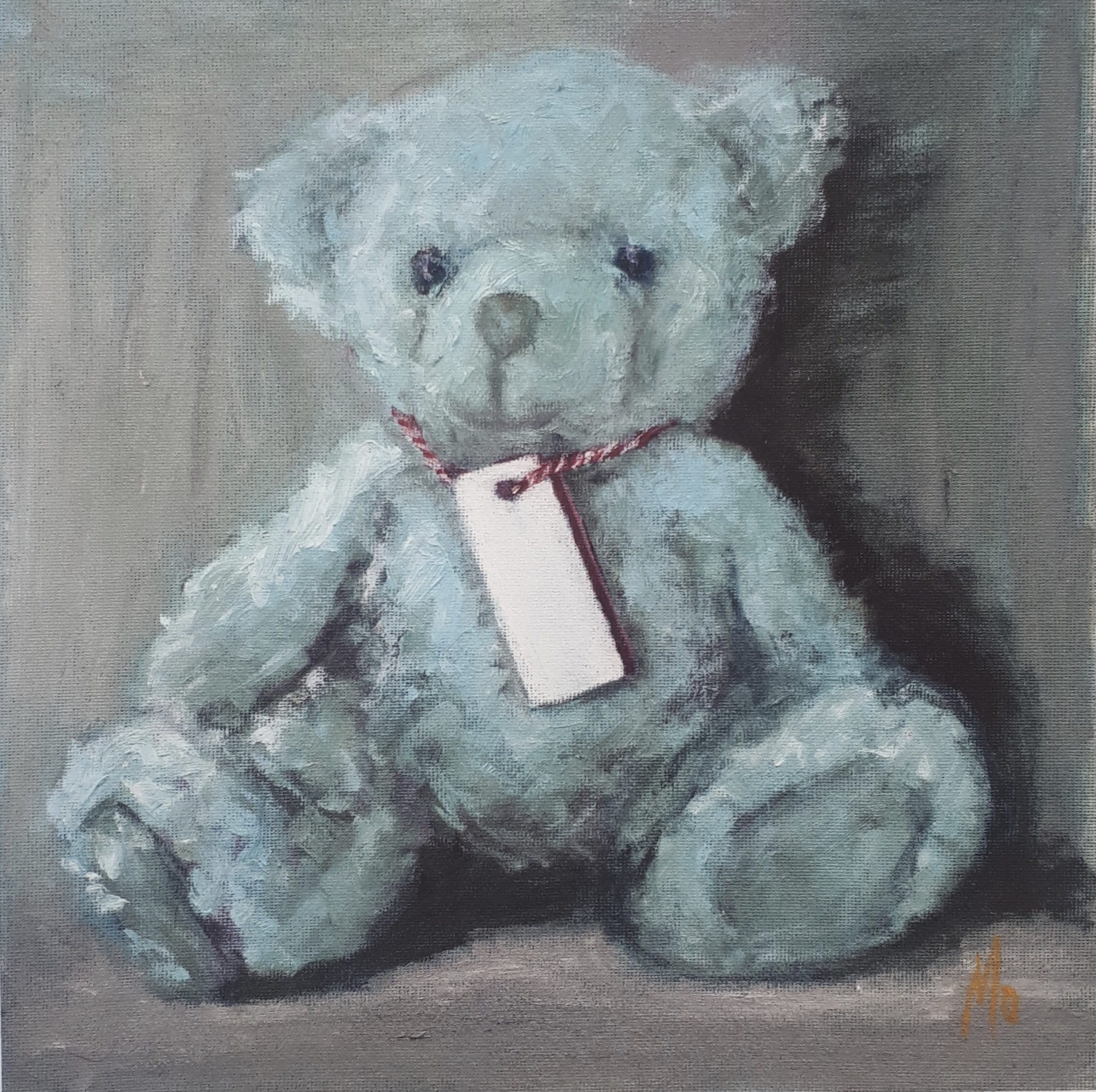 Little Blue Teddy Bear with tag around its neck