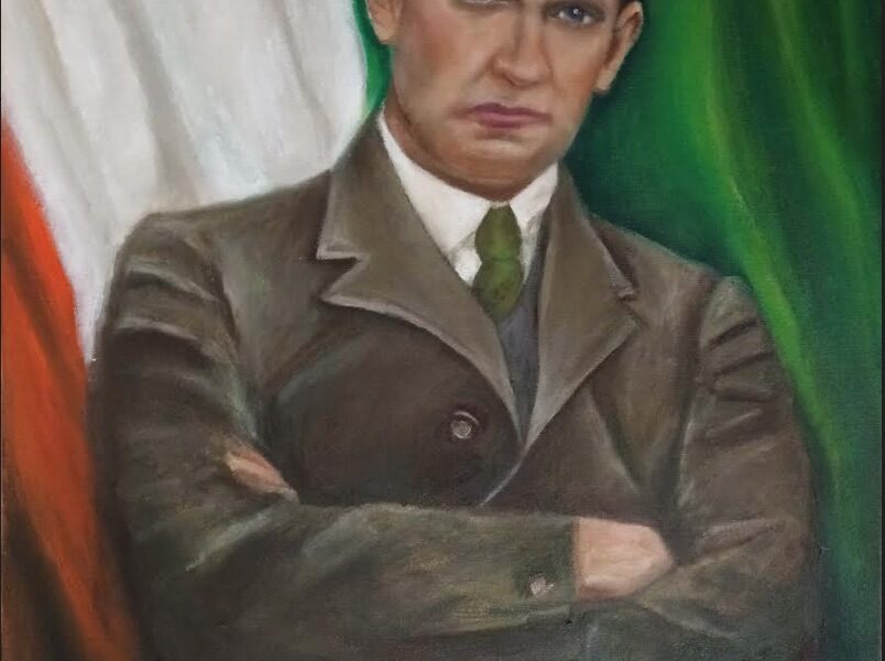 Micheal Collins sitting in front of the tricolour