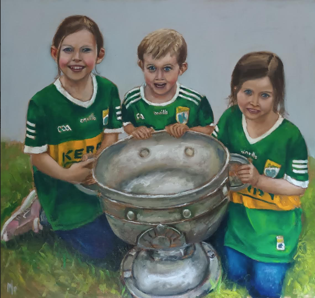 Three children Kerry jerseys and the Sam Maguire